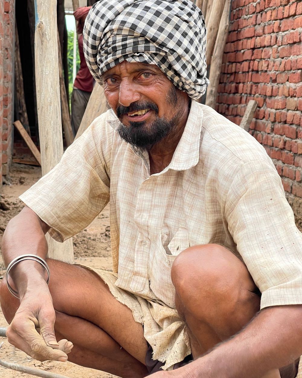 A smiling farmer in a checked turban