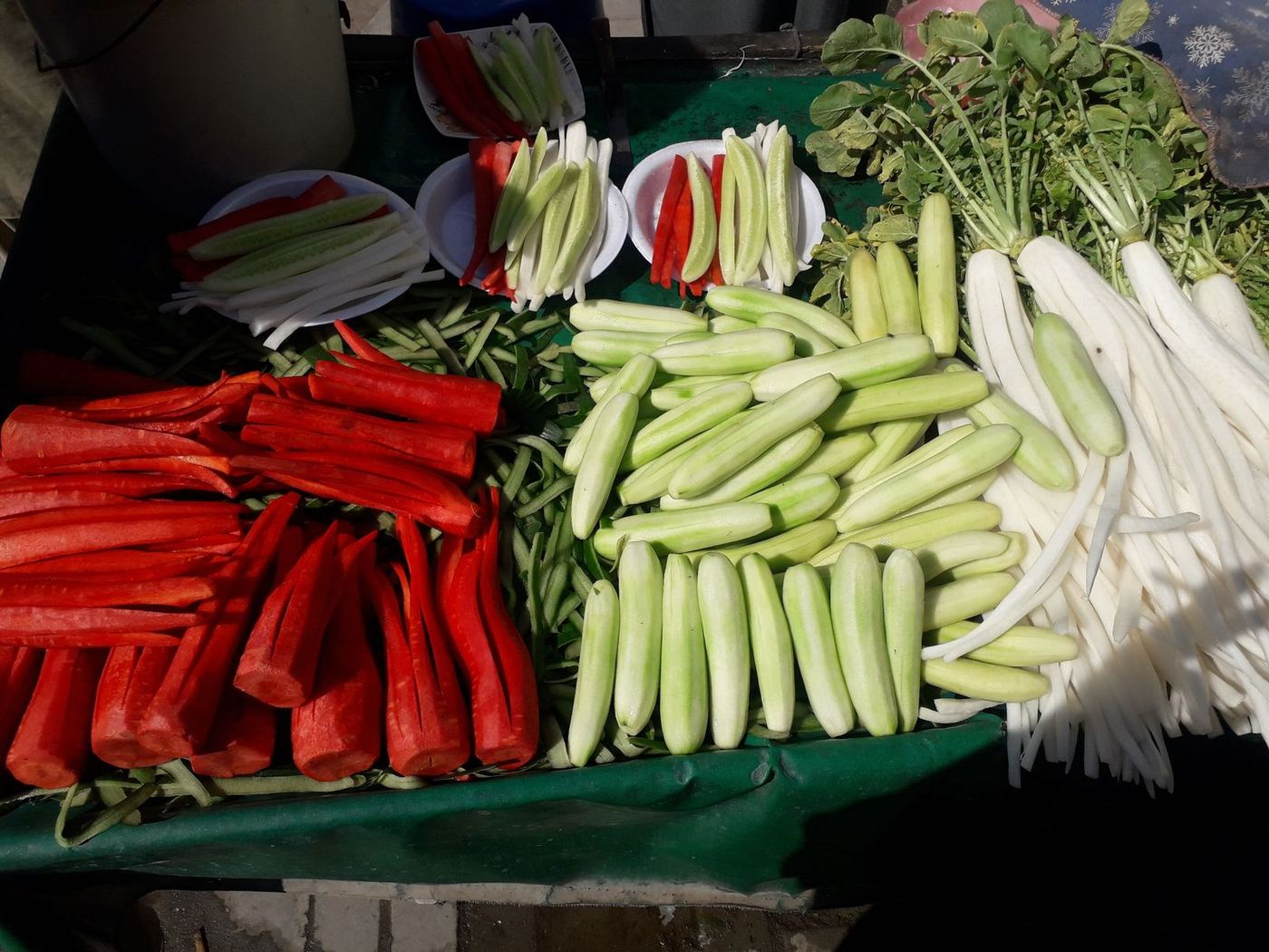 Winter red carrots, cucumbers and mooli at a village stall